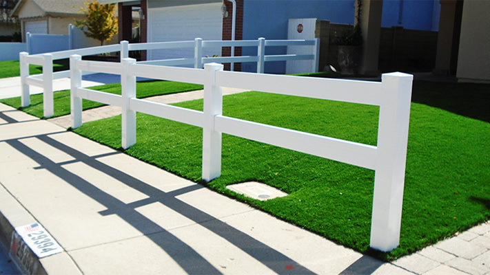 White two-rail ranch rail fence in front of a home, some of our property management fencing for houses in Westlake Village, California.