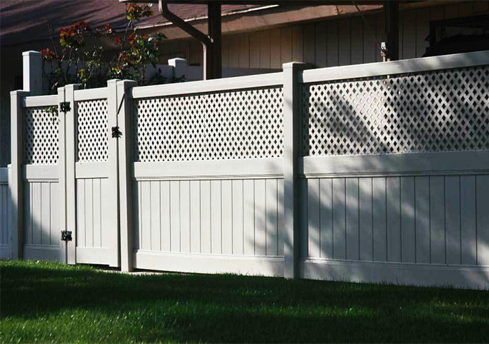 Tan semi-privacy fencing with gate at a house, a showcase of quality vinyl fencing near Caruthers.